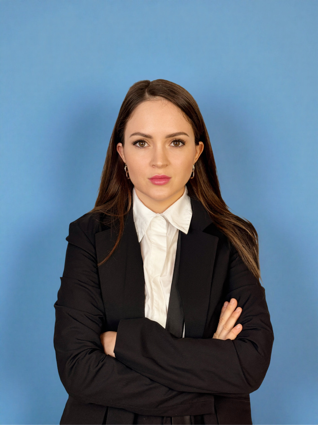 Anna Kovalova in a black blazer against a blue background